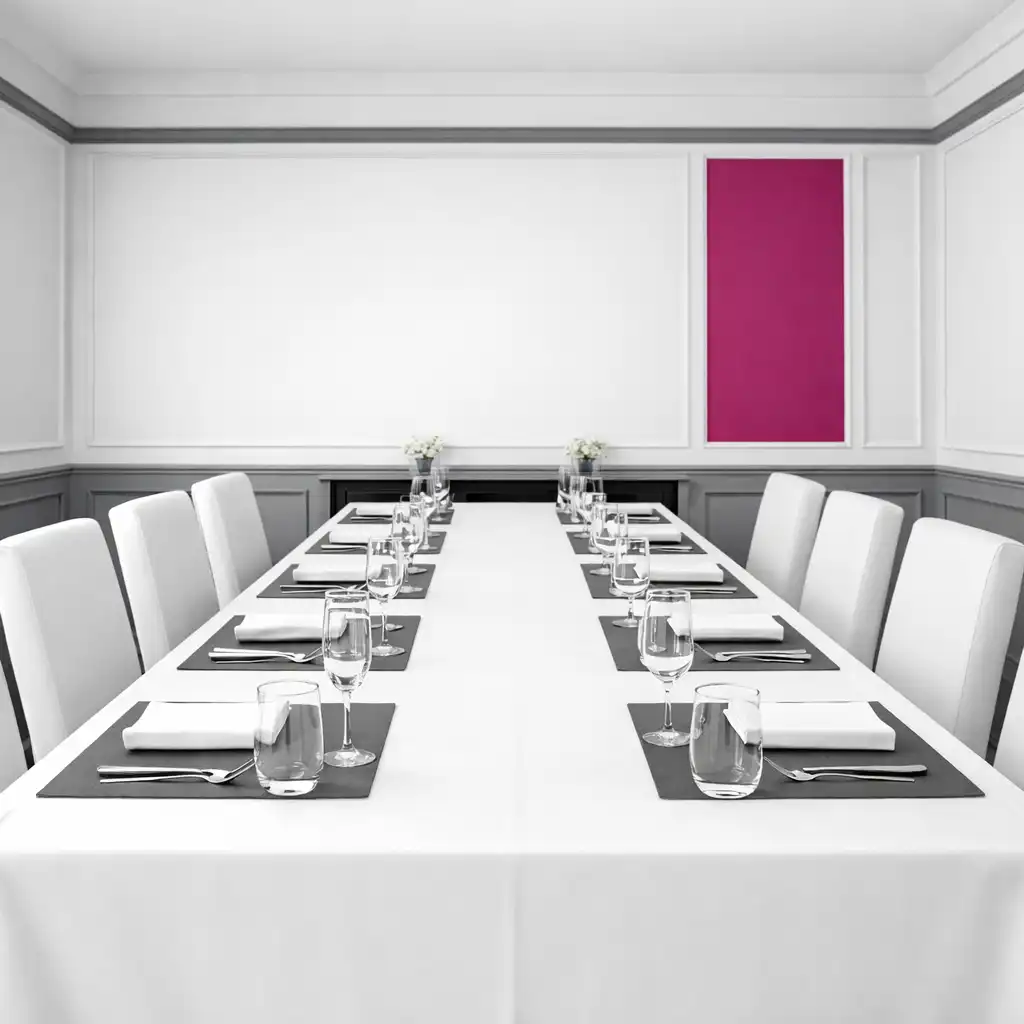 Interior view of the private dining room with a long table set in white and graphite