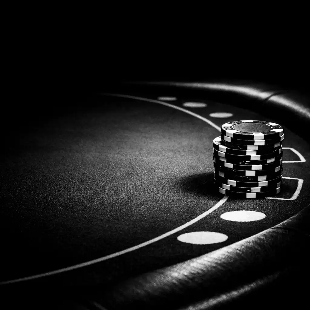 Close-up of a poker table with chips as props and dark felt